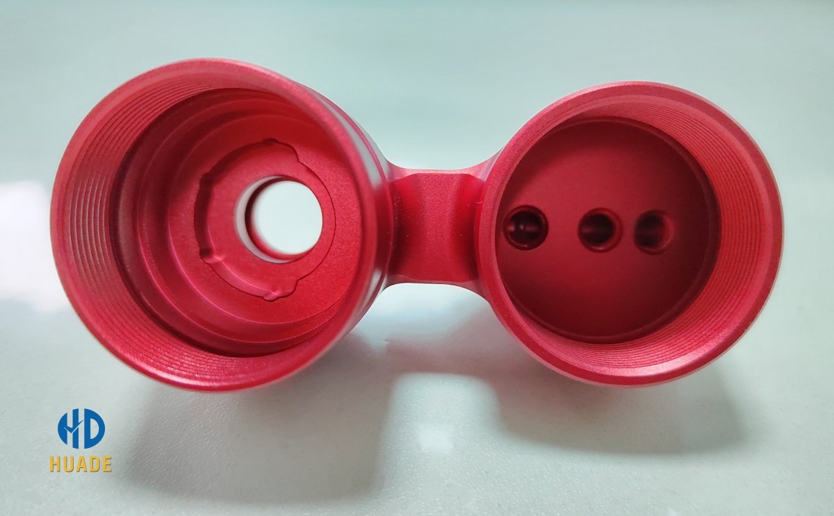 CNC anodized aluminum part with red coating showing advanced surface finishing technologies
