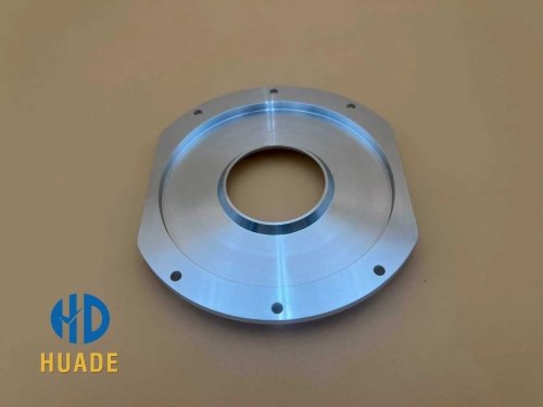 Close-up of CNC-machined compression driver parts in 5074 aluminum, showing precision threads and phase plug interface.